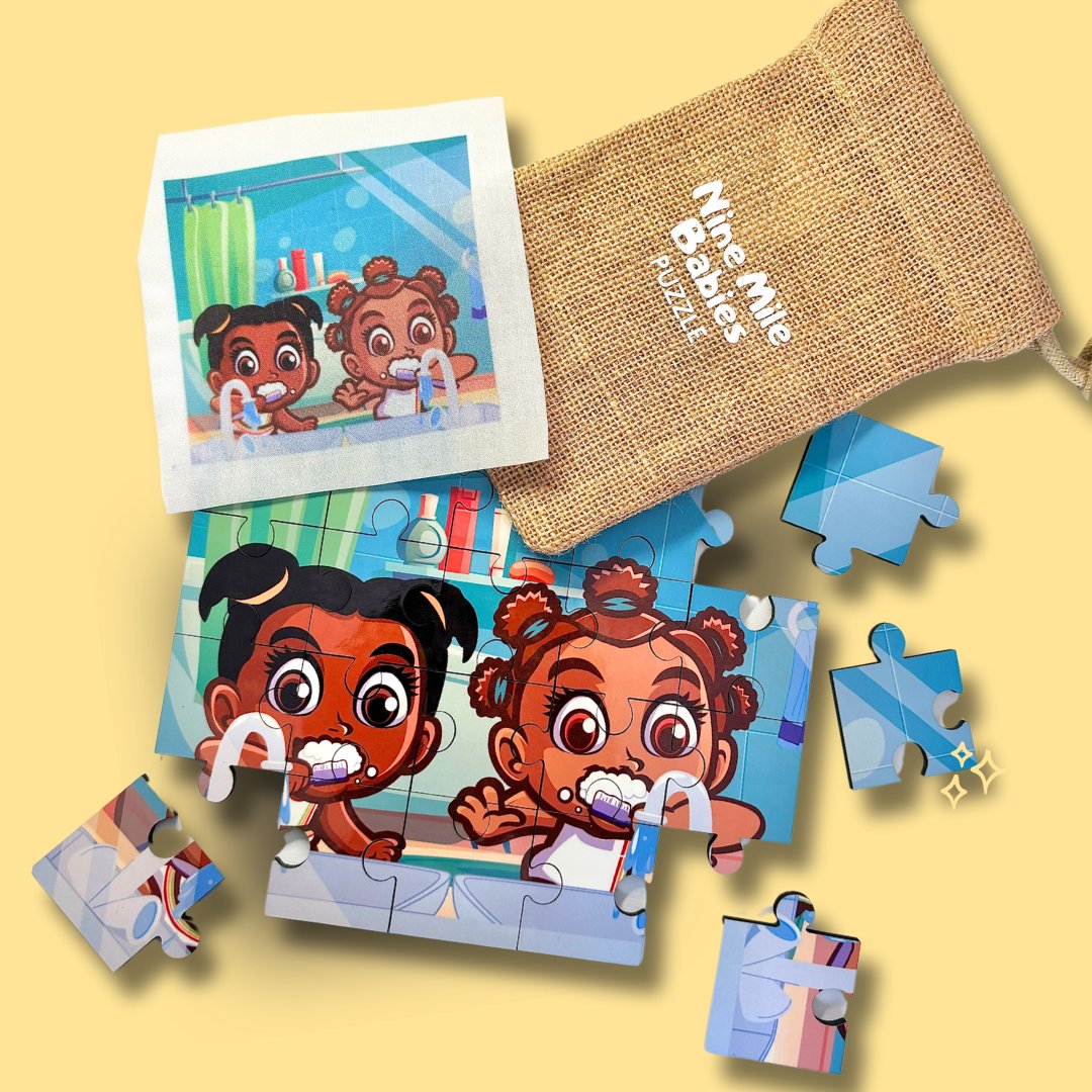 Two small hands of a child are putting together a jigsaw puzzle on the tabletop. The puzzle pieces feature Nine Mile Babies designs with a drawstring bag with the logo on it. The scene captures a moment of playful engagement and concentration.